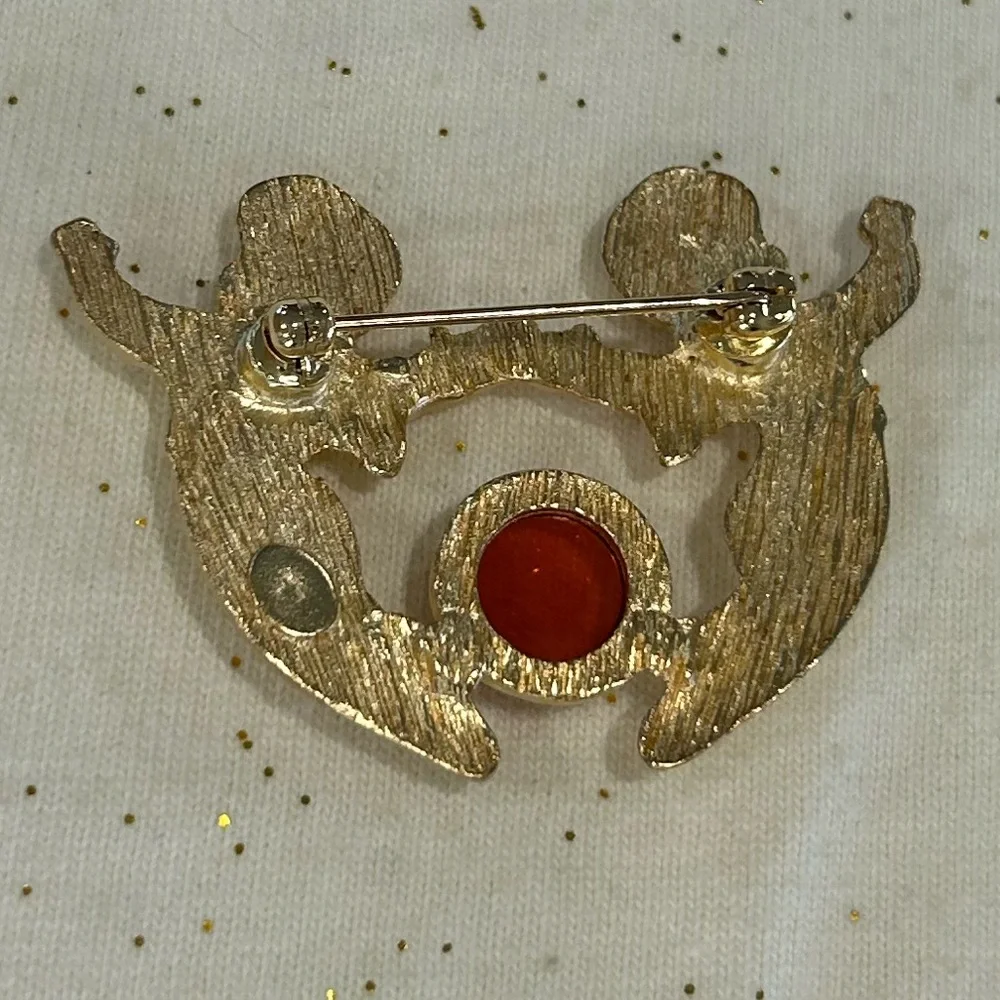 New Vintage Louis Stern (LS) gold-tone cherub brooch with a faux amber cabochon.